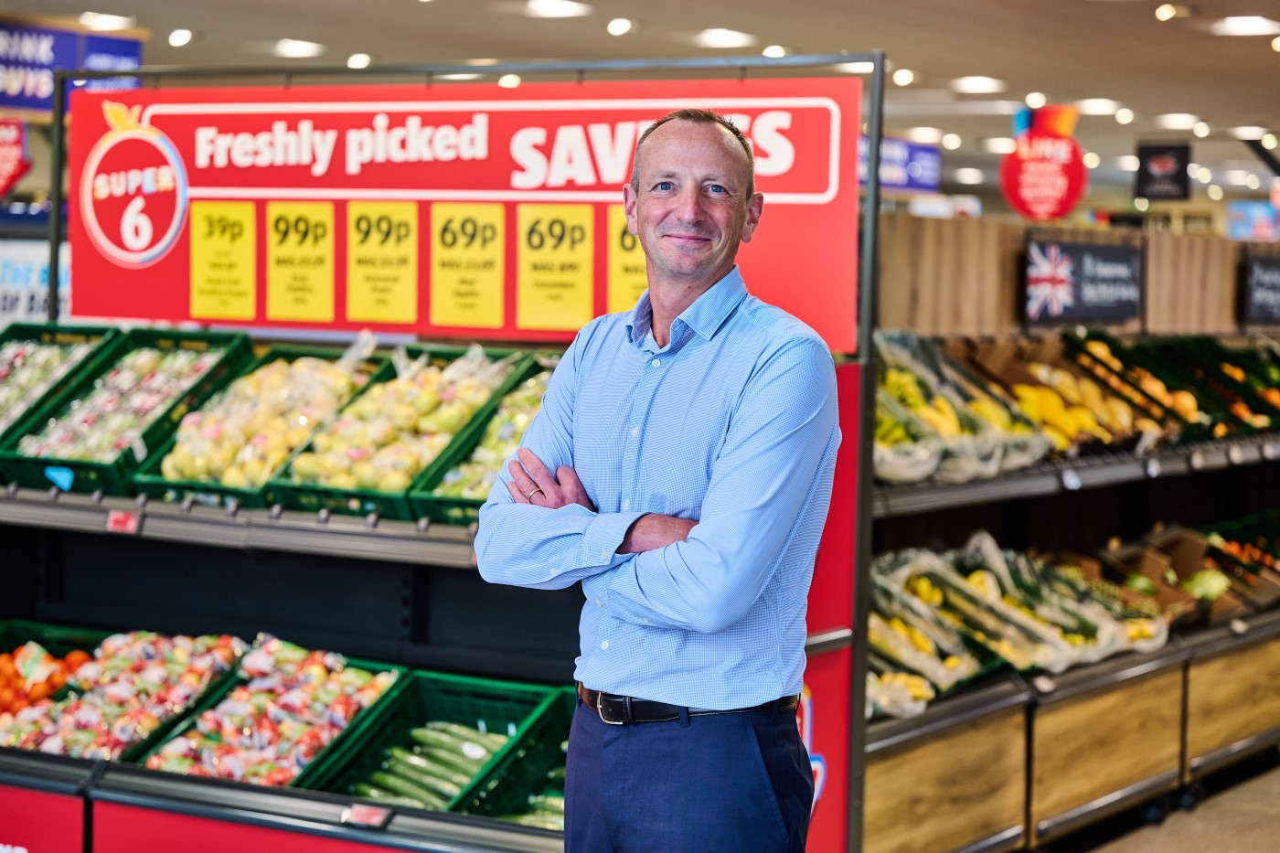 Giles Hurley, CEO of Aldi UK and Ireland, standing in an Aldi store.